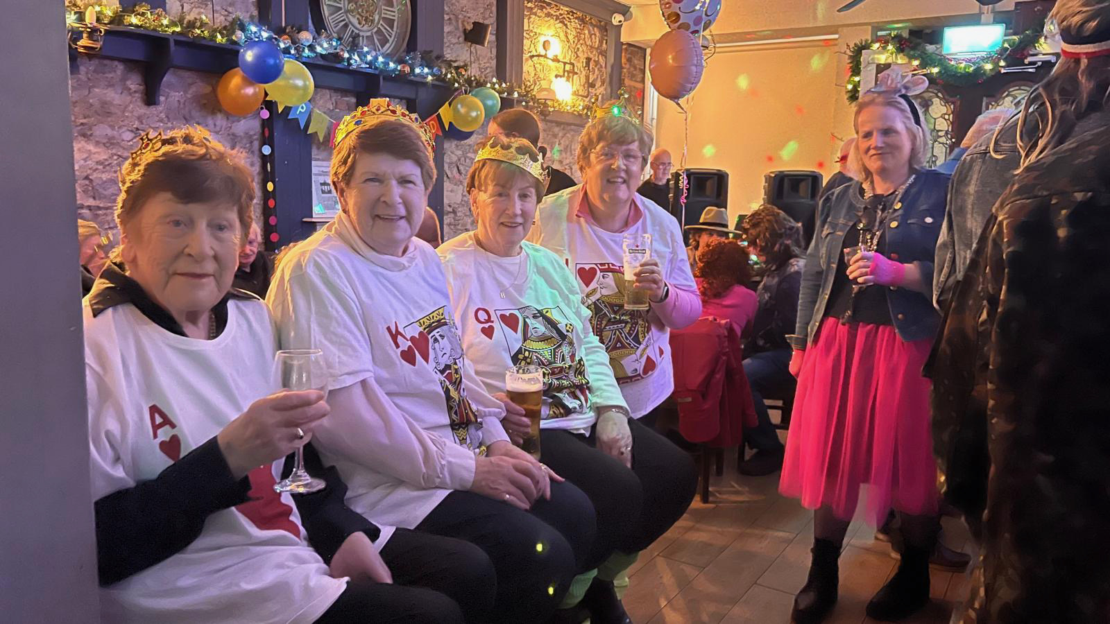 Friends in king & queen of hearts shirts at a Mick Burke's party